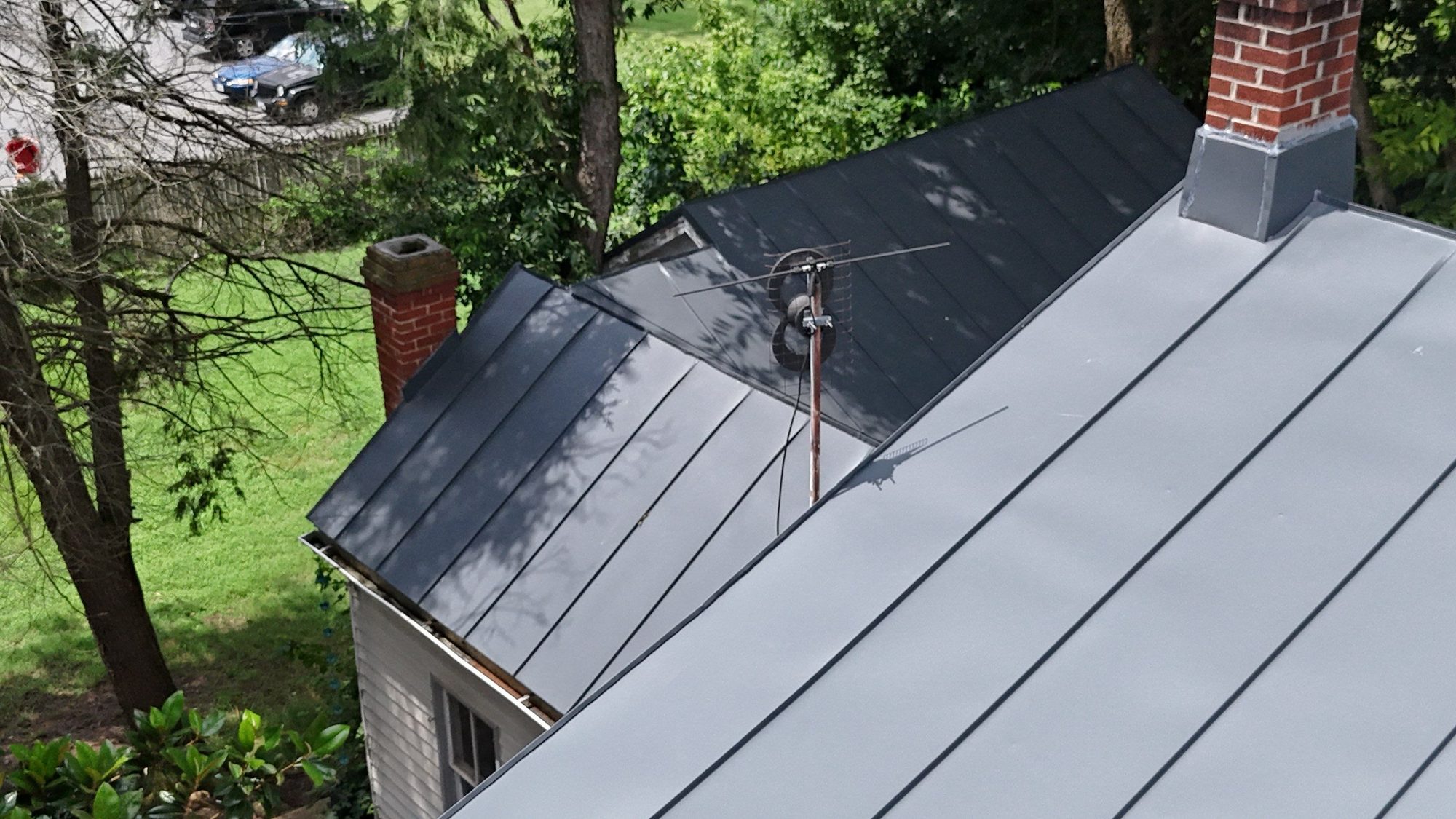 Standing-seam roof in a wooded neighborhood