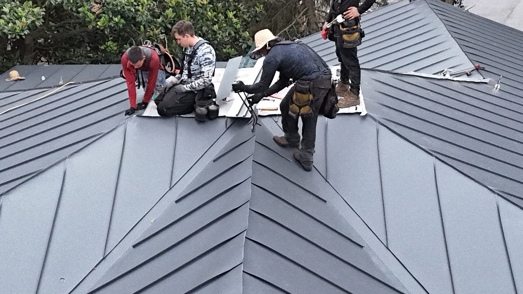 ORA crew working on a standing-seam roof